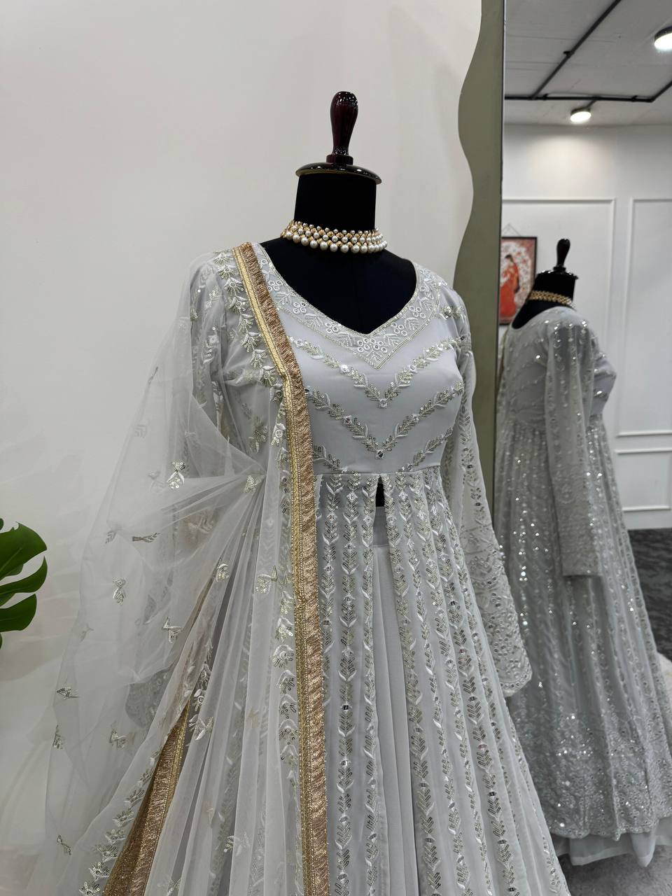 Elegant three-piece ensemble featuring a faux georgette top and lehenga with dupatta